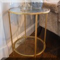 F14. Gold-toned tiered glass top table. 24"h x 18"w 